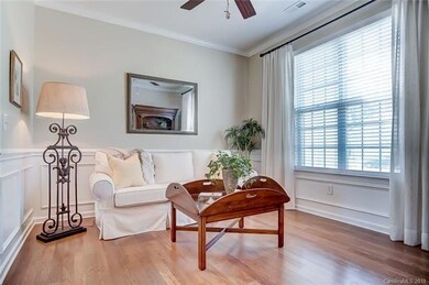 Sitting Room with Wood Flooring and Wainscot Moldi