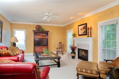 large family room with gas fireplace and crown mol