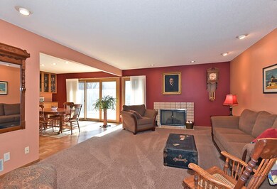 The Living Room boasts a fireplace and is open to 