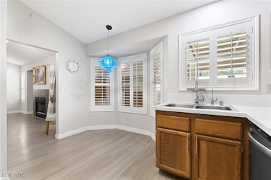 Kitchen featuring dishwasher, light wood-style flo