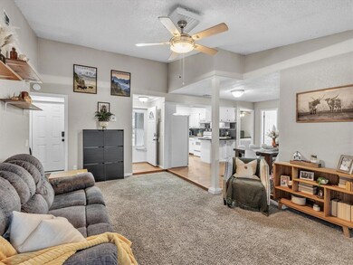 Carpeted living room featuring a textured ceiling,
