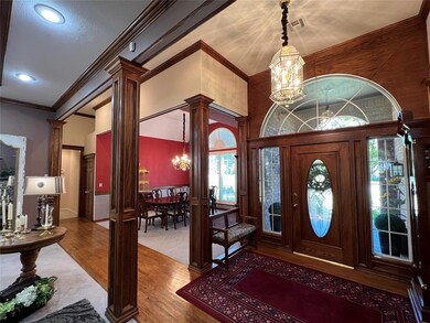 Foyer with ornate columns, ornamental molding, woo
