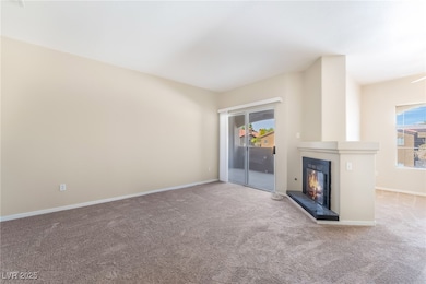 Unfurnished living room with a large fireplace and carpet flooring