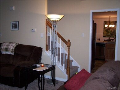 Family room with view toward kitchen and stair cas