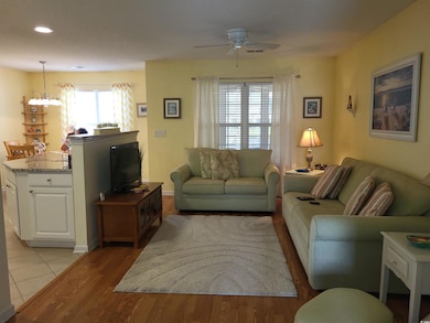 Living area with baseboards, light wood-style floo