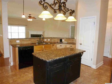 A chef's dream kitchen with center island, granite counter tops, ceramic tile back splash, and large pantry.