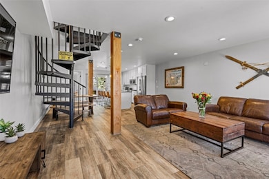 Living area with stairs, recessed lighting, and wo