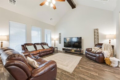 Living room featuring wood finish floors, beam cei