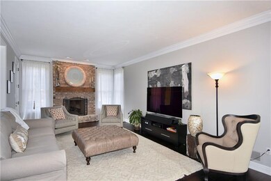 Family room features a timeless brick fireplace an