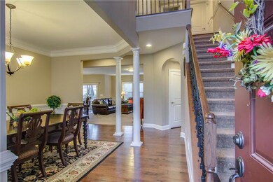 What an entrance!  Elegant staircase with wrought iron spindles, wood floors and more.