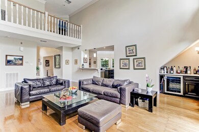 Living room with small mini bar under stairs with