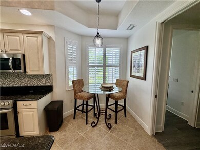 Dining area featuring baseboards, a tray ceiling,