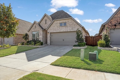 View of front of property featuring brick siding, a front yard, and concrete driveway