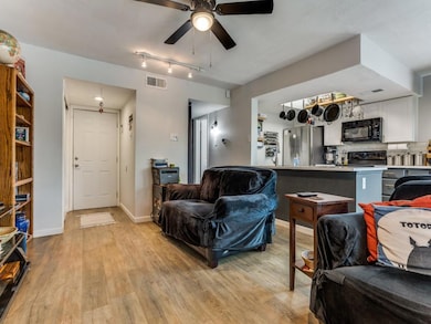 Living room with light wood-type flooring, baseboa