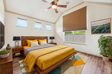 Bedroom with crown molding, wood finished floors,