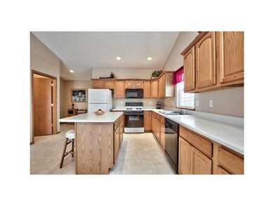 Kitchen. A CENTER ISLAND, CROWN MOLDING, AND FIRST