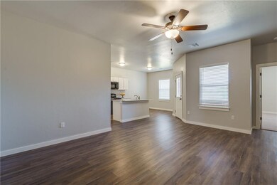 View from living room into kitchen and master.
