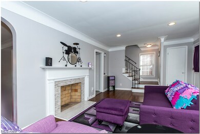 Living room with ornamental molding and decorative fireplace