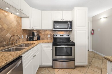 Kitchen - Double stainless sinks with tile floorin
