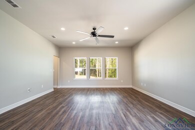 Spare room featuring ceiling fan and dark hardwood