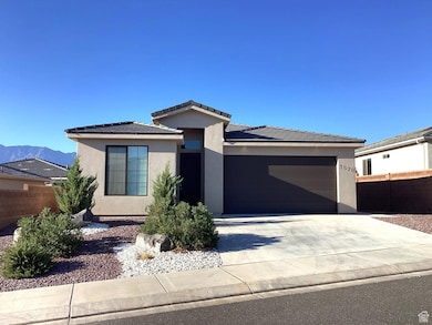 Prairie-style house featuring concrete driveway, stucco siding, an attached garage, and a tiled roof
