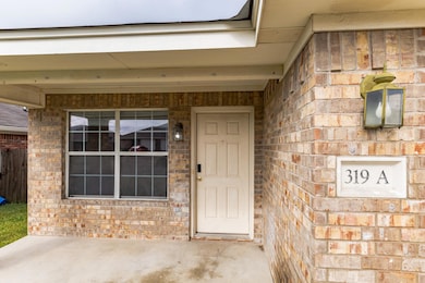 Entrance to property featuring brick siding