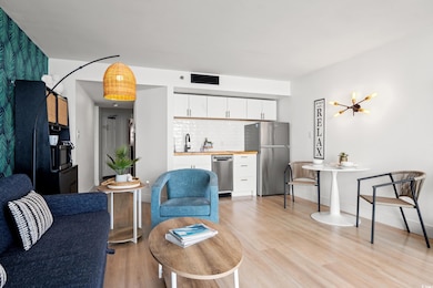 Living room featuring light wood-style floors and bar