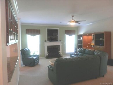 Family Room w/ Fireplace and Crown Molding