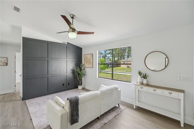 Living room with ceiling fan, wood finished floors