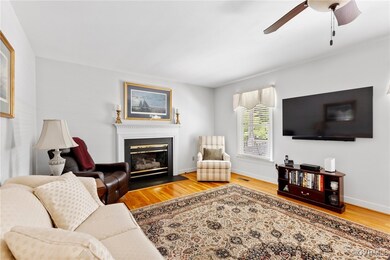 Living room with wood finished floors, a ceiling f