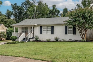Single story home featuring a front yard and cover