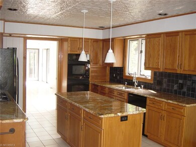 Opulent granite countertops and rich cabinetry gra