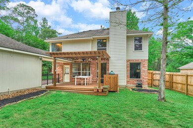 Well manicured yard with mature trees, above ground planters, and an incredible deck w/pergola for year-round outdoor living at its finest!