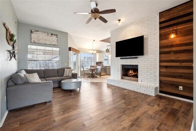 Living area featuring a brick fireplace, a ceiling