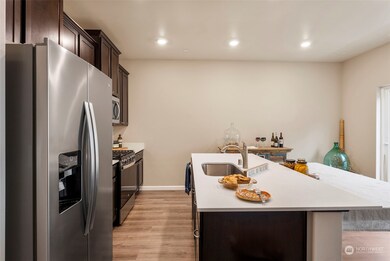 Open-plan Galley Kitchen Layout, Large Island, Quarz, EnergySaver Stainless appliances. Shares gas fireplace, TV, island. Enjoys NE-facing morning light.