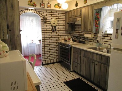 Generous working kitchen with ceramic flooring.