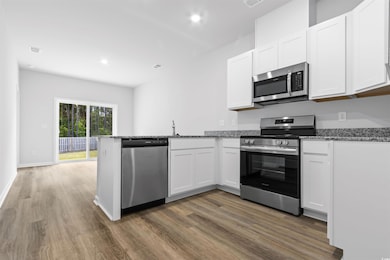 Kitchen featuring white cabinetry, kitchen peninsu