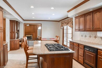Spacious, open kitchen with tile flooring and back