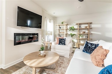 Living room with a glass covered fireplace, basebo