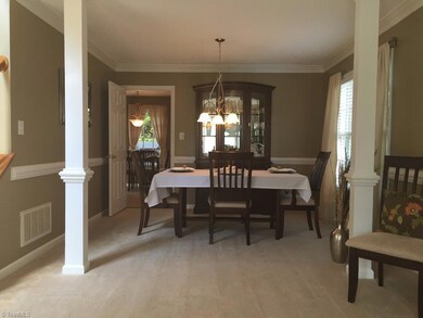 Elegant dining....columns to define between living area, crown/chair moldings, double window with 2