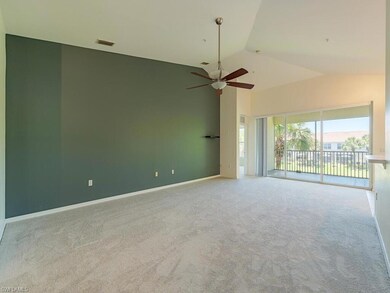Carpeted spare room featuring high vaulted ceiling