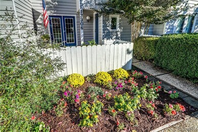 Front private parking pad is bordered with landsca