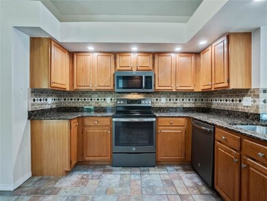 Kitchen with granite counters and pull out shelves