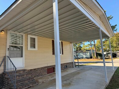 View of patio with a carport