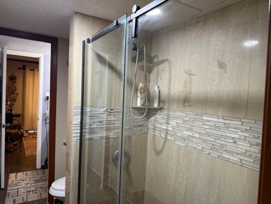 Beautifully tiled shower with glass doors! Leads f