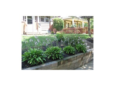 Entry way has elevated flower beds with concrete w