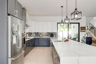 Kitchen with stainless steel fridge with ice disp