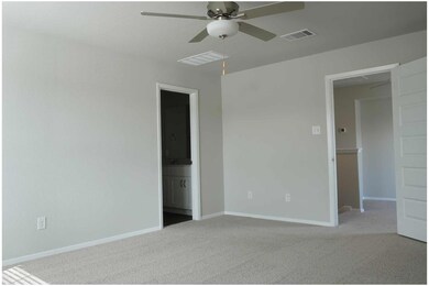 Unfurnished bedroom with carpet flooring, ensuite