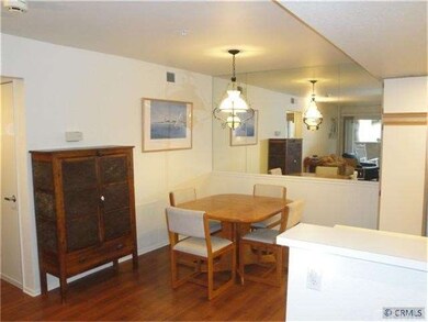 Dining room area with mirrored wall and wainscotti