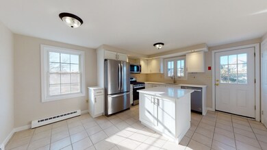 Unit A - Eat-in Kitchen with new cabinets and appliances.  Side entrance from the driveway and parking area.